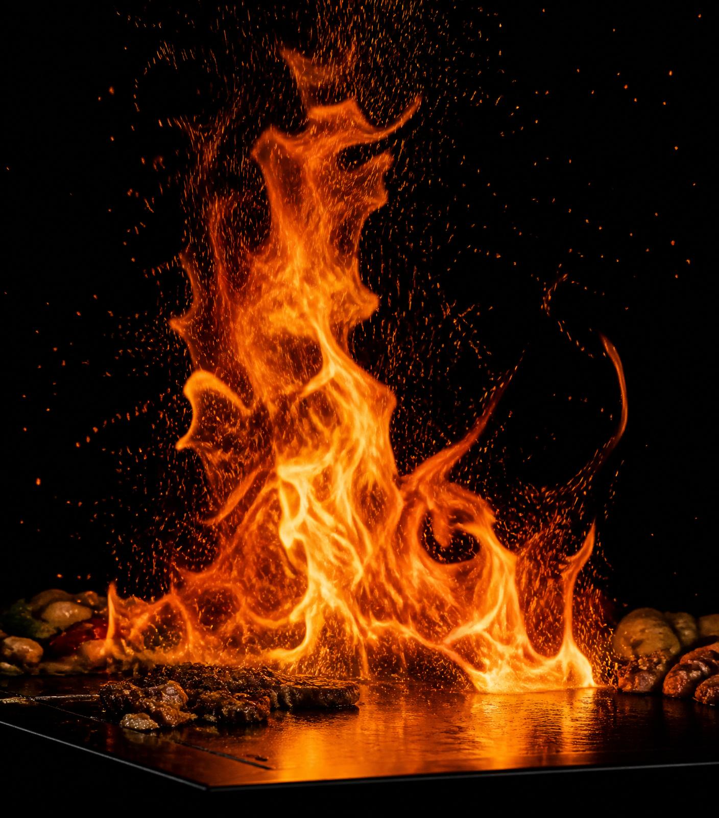Tall flames erupting from a hibachi grill